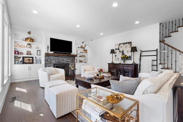 living room featuring recessed lighting, a fireplace, stairs, visible vents, and dark wood finished floors