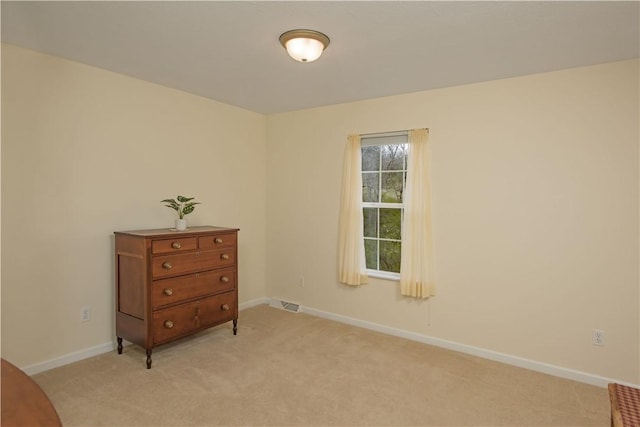 bedroom featuring light colored carpet, baseboards, and visible vents