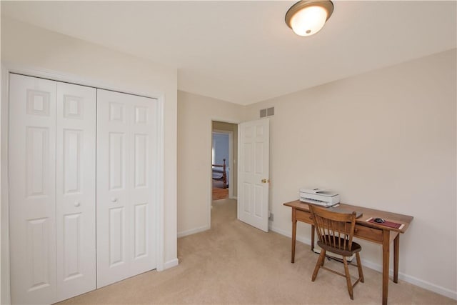 office area featuring light colored carpet, baseboards, and visible vents