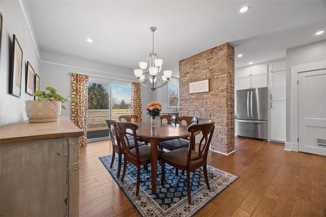 dining room featuring recessed lighting, an inviting chandelier, and hardwood / wood-style flooring
