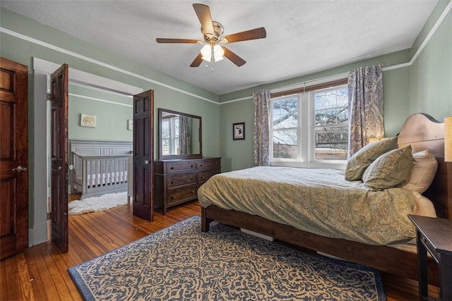 bedroom with ceiling fan and hardwood / wood-style flooring