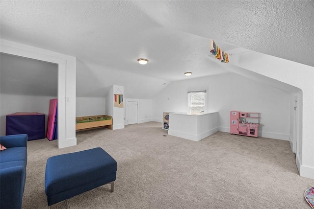 interior space with carpet flooring, vaulted ceiling, and a textured ceiling