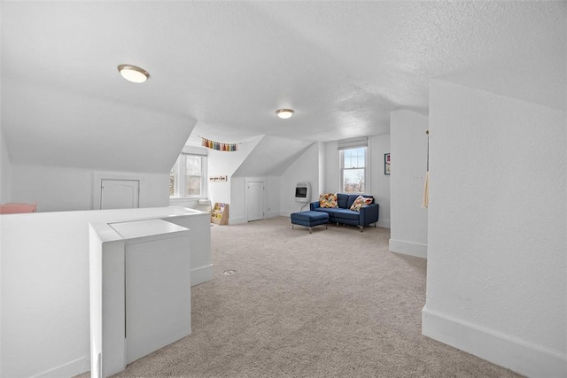 bonus room featuring carpet floors, baseboards, a textured ceiling, and lofted ceiling