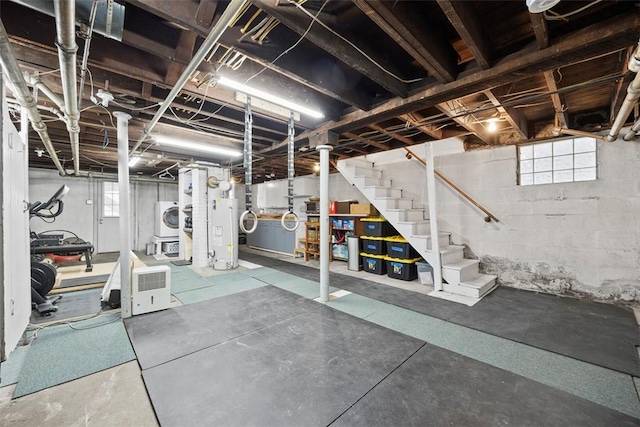 basement featuring stairway, water heater, and washer / dryer