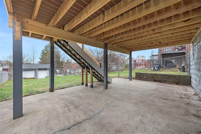 view of patio / terrace with an outdoor structure, fence, and stairway