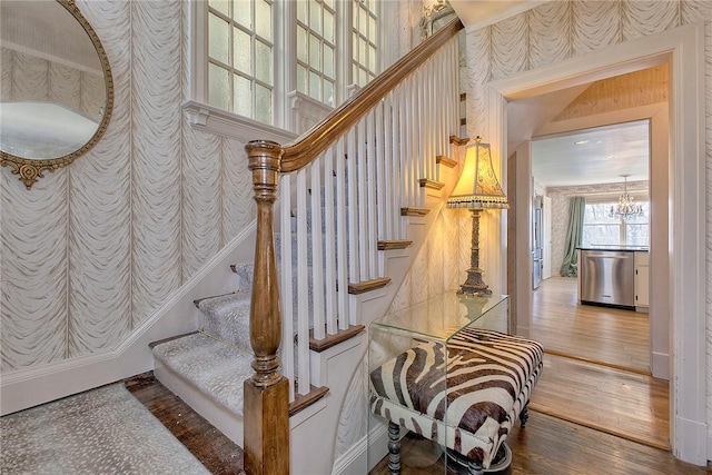 552 N Maple Ave, City Of Greensburg, PA 15601 - stairs with a chandelier, wallpapered walls, and wood finished floors
