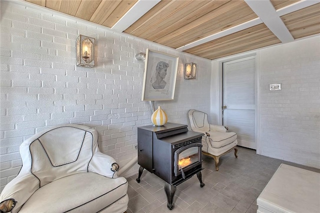 552 N Maple Ave, City Of Greensburg, PA 15601 - sitting room with brick wall, a wood stove, and wood ceiling