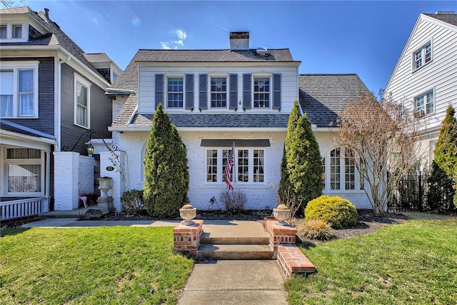 552 N Maple Ave, City Of Greensburg, PA 15601 - view of front facade featuring a front yard, a shingled roof, brick siding, and a chimney
