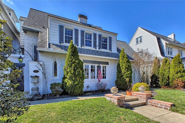 552 N Maple Ave, City Of Greensburg, PA 15601 - view of front of home with roof with shingles, a chimney, a front lawn, and brick siding
