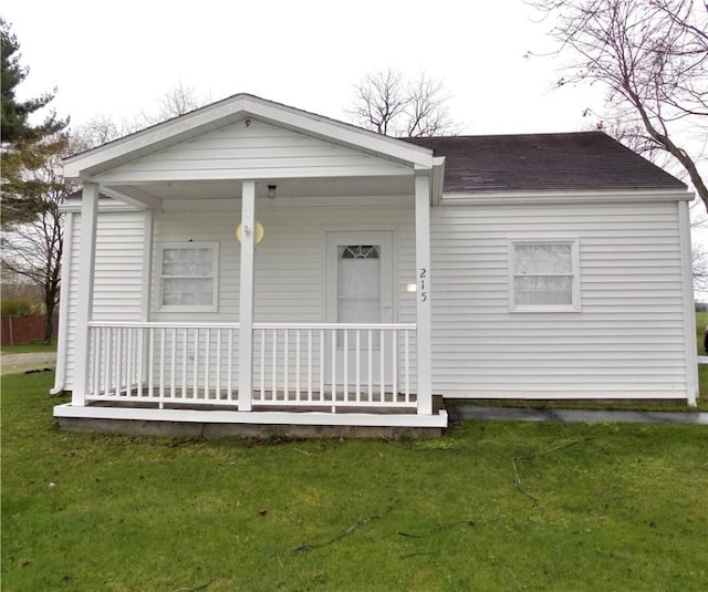 215 Maple St, Carmichaels/Cumblnd, PA 15320 - view of front of home featuring a shingled roof, covered porch, and a front lawn