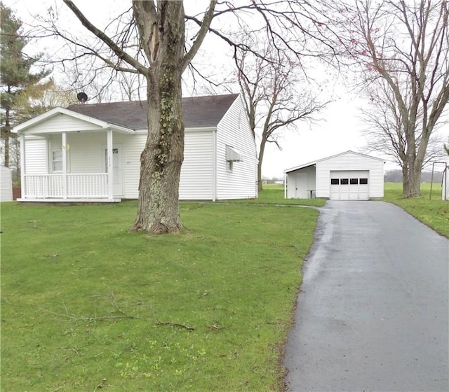 215 Maple St, Carmichaels/Cumblnd, PA 15320 - view of front facade with a front yard, a porch, and an outbuilding