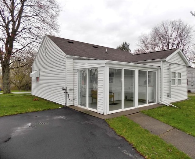 215 Maple St, Carmichaels/Cumblnd, PA 15320 - view of home's exterior featuring a sunroom and a lawn