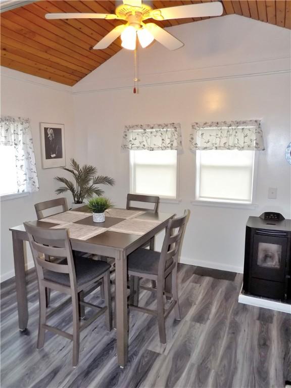 215 Maple St, Carmichaels/Cumblnd, PA 15320 - dining room featuring a wood stove, ceiling fan, wood ceiling, wood finished floors, and lofted ceiling
