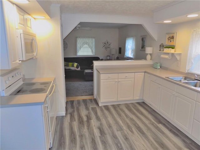 215 Maple St, Carmichaels/Cumblnd, PA 15320 - kitchen with a sink, light countertops, light wood-type flooring, white appliances, and white cabinetry