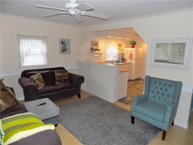 215 Maple St, Carmichaels/Cumblnd, PA 15320 - living room with light wood-style floors, crown molding, and ceiling fan