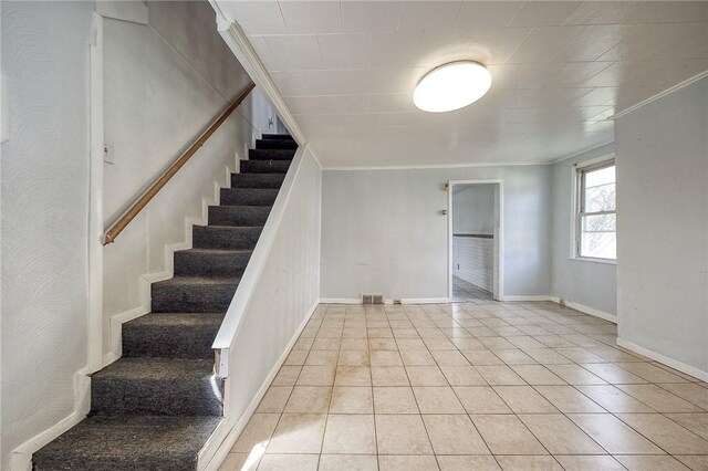 627 Rostraver Rd, Belle Vernon, PA 15012 - stairs featuring tile patterned floors, baseboards, and ornamental molding