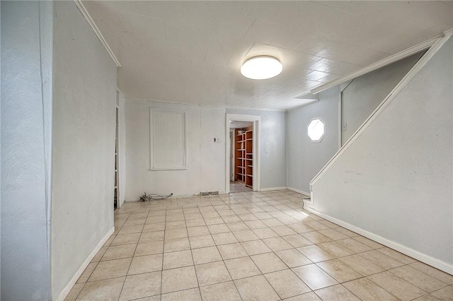 627 Rostraver Rd, Belle Vernon, PA 15012 - spare room with ornamental molding, baseboards, stairway, and light tile patterned floors
