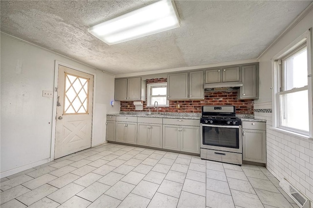 627 Rostraver Rd, Belle Vernon, PA 15012 - kitchen featuring visible vents, stainless steel gas stove, gray cabinetry, and a textured ceiling