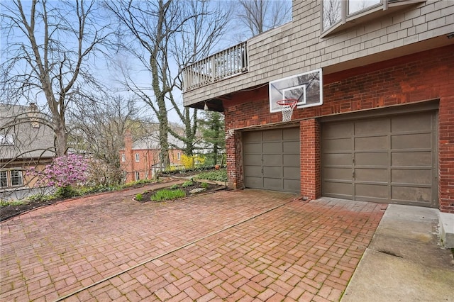 garage featuring decorative driveway