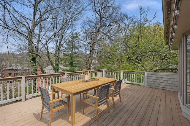 wooden terrace featuring outdoor dining area