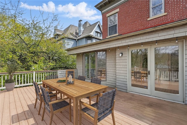 wooden deck featuring outdoor dining area