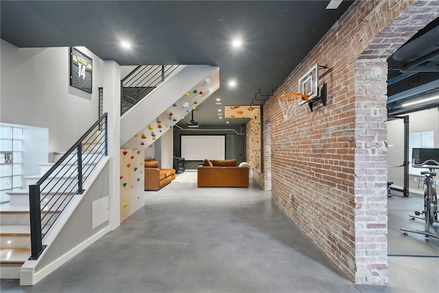 interior space with brick wall, recessed lighting, and stairs