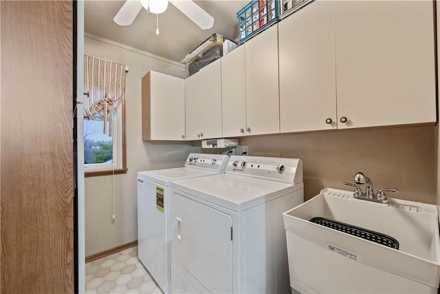 clothes washing area featuring washing machine and clothes dryer, crown molding, cabinet space, ceiling fan, and a sink