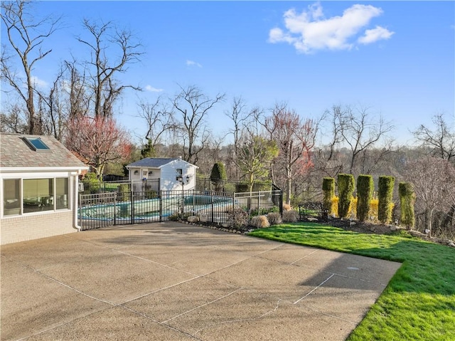 view of community with a yard, a pool, fence, a patio, and an outbuilding