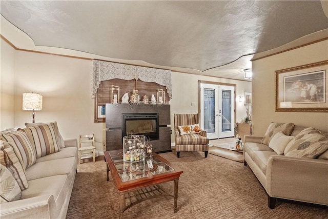 carpeted living area featuring a glass covered fireplace, french doors, and ornamental molding