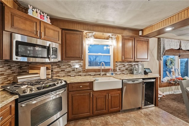 kitchen with brown cabinets, a sink, and appliances with stainless steel finishes