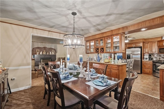 carpeted dining space featuring a chandelier