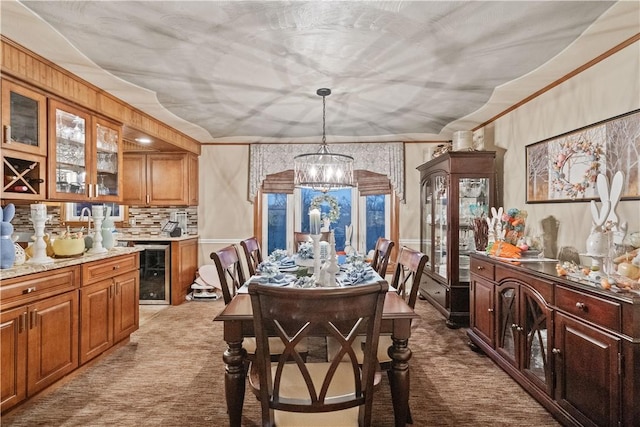 dining area featuring plenty of natural light, a notable chandelier, light colored carpet, and beverage cooler