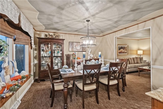 carpeted dining space featuring a notable chandelier, ornamental molding, and baseboards
