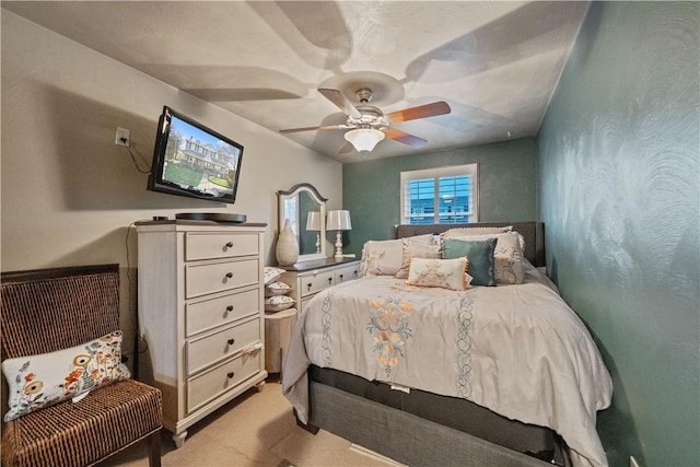 bedroom featuring a ceiling fan and light carpet