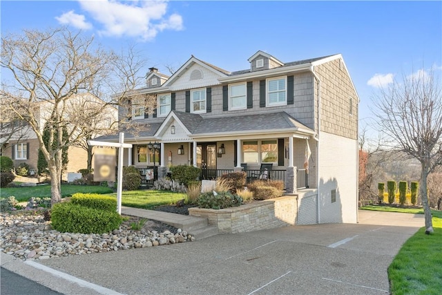 view of front of house featuring a porch and brick siding