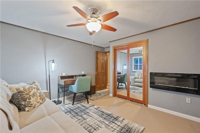 office space with ornamental molding, baseboards, ceiling fan, and carpet flooring