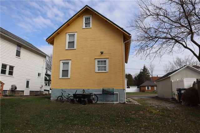 back of house featuring a lawn