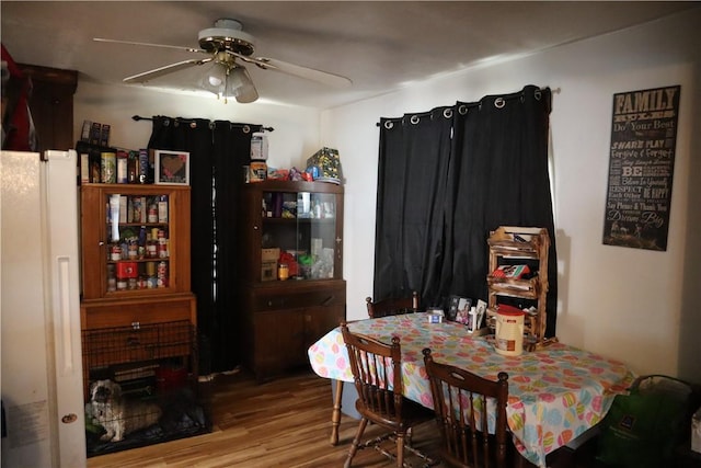 dining room featuring wood finished floors and ceiling fan