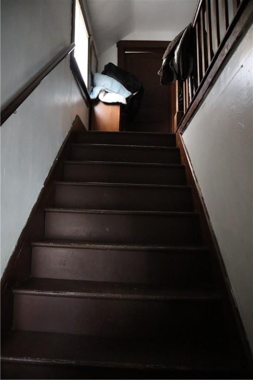 staircase featuring vaulted ceiling