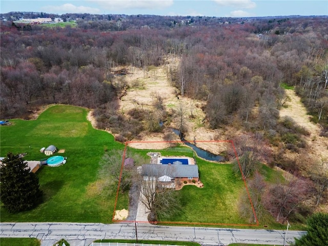 birds eye view of property with a forest view