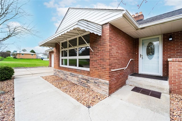 view of exterior entry with brick siding