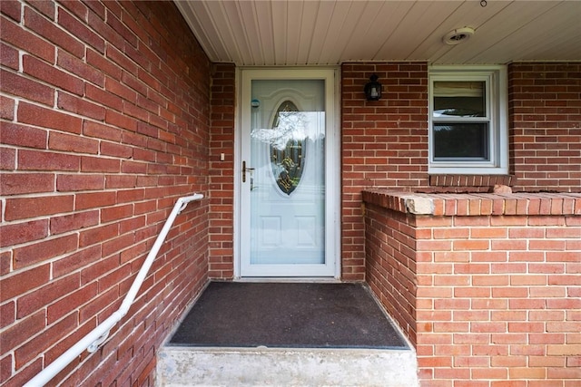 view of exterior entry with brick siding