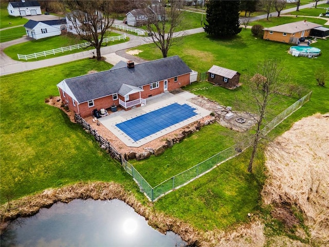 birds eye view of property with a water view