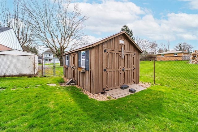 view of shed with fence and a gate