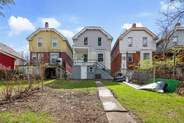 1523 Westmoreland Ave, Lincoln-Larimer, PA 15206 - back of house featuring a yard, stairway, fence, a chimney, and central AC unit