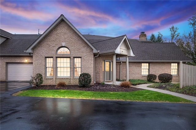 325 Village Green Dr, Peters Twp, PA 15317 - view of front of house with a chimney, a garage, driveway, and brick siding