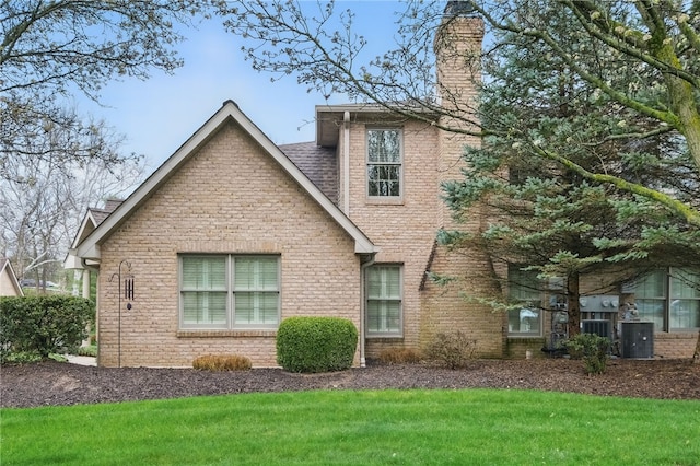 325 Village Green Dr, Peters Twp, PA 15317 - back of house featuring a yard, brick siding, a chimney, and a shingled roof