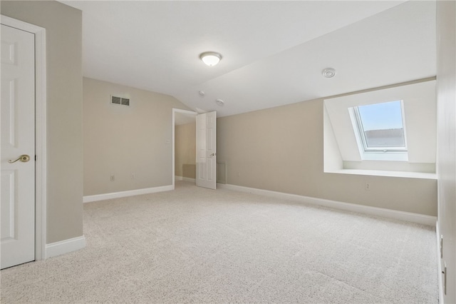 325 Village Green Dr, Peters Twp, PA 15317 - unfurnished bedroom featuring vaulted ceiling with skylight, carpet flooring, baseboards, and visible vents
