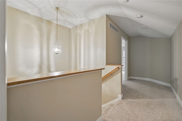 325 Village Green Dr, Peters Twp, PA 15317 - hallway with an inviting chandelier, carpet, vaulted ceiling, visible vents, and baseboards