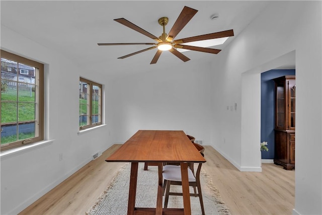dining space with light wood-style flooring, ceiling fan, baseboards, and visible vents